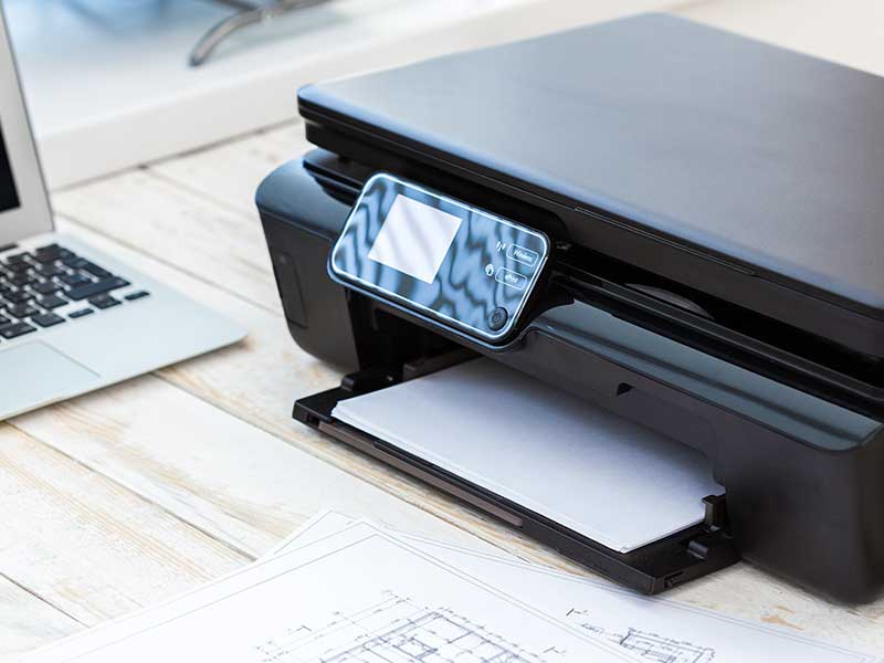 printer and laptop on table