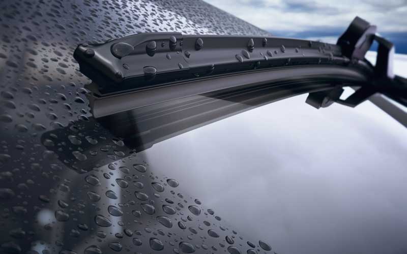 rubber wiper blade removing rain on windshield