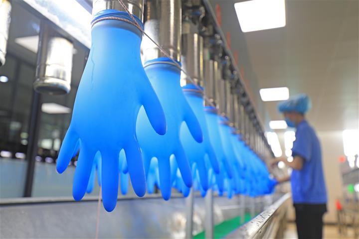 Latex glove factory where gloves are inflated on assembly line